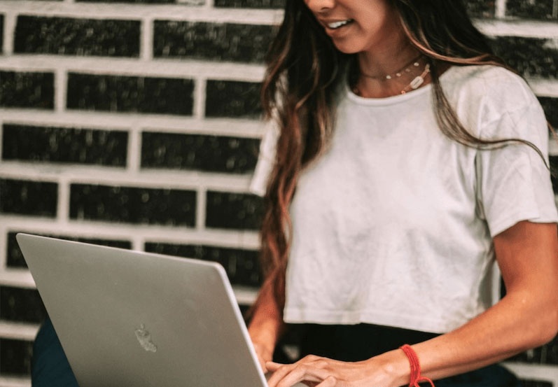 Woman taking an online virtual meditation class with The DEN Meditation